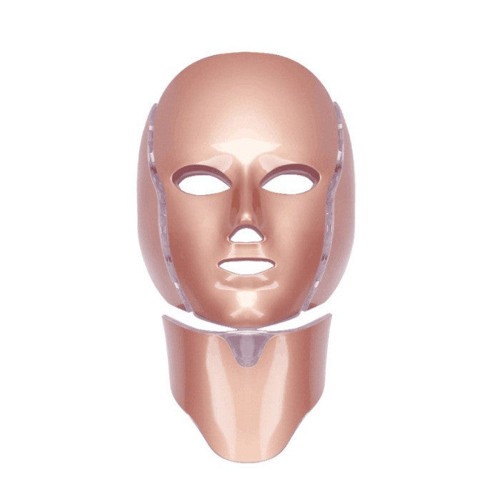 Masque LED pour visage et cou, couleur rose doré, vue frontale montrant les ouvertures pour les yeux et la bouche avec sangles latérales.