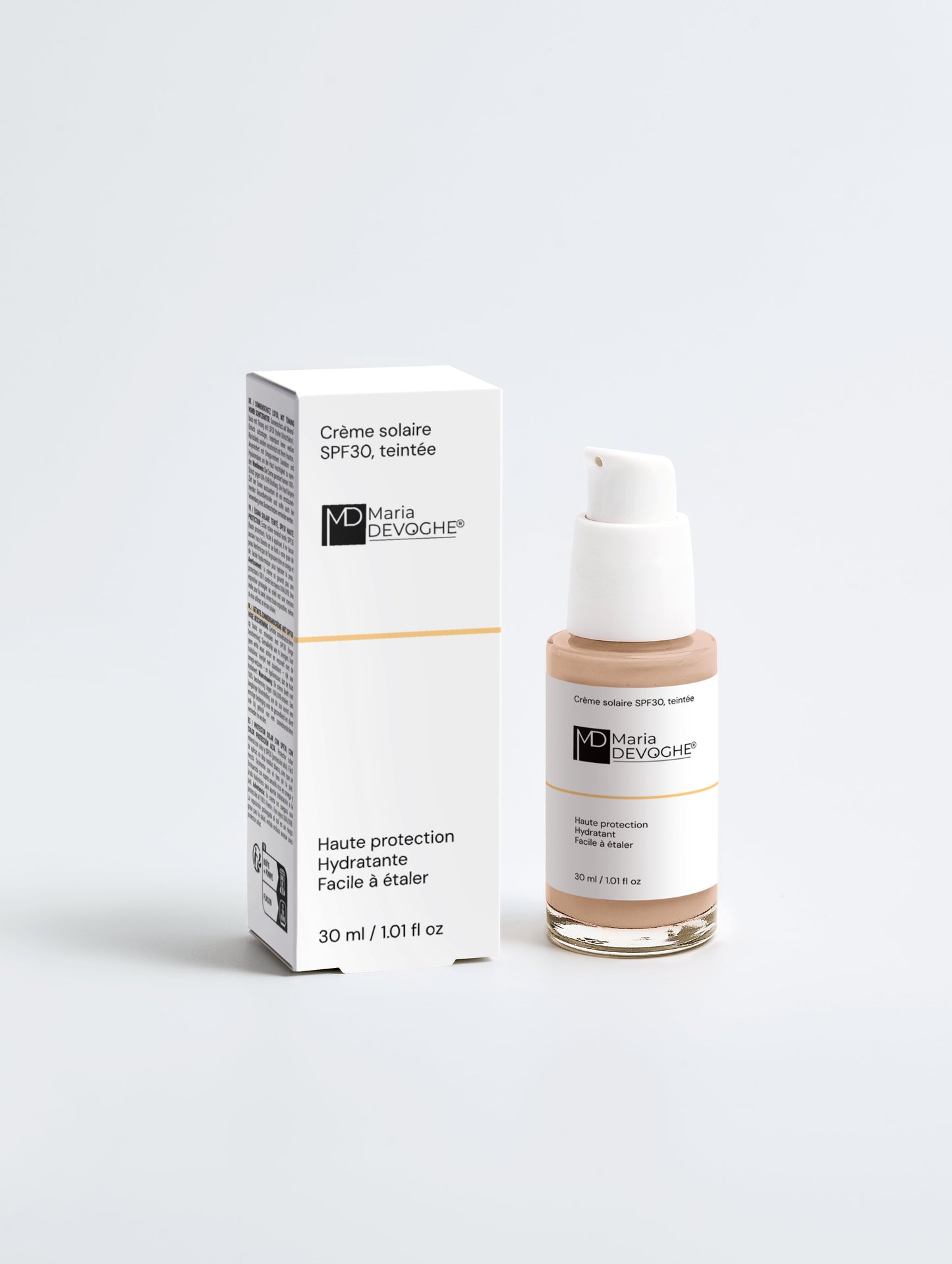Crème solaire teintée SPF30 Maria Devoghe avec son flacon pompe et boîte blanche, design épuré.