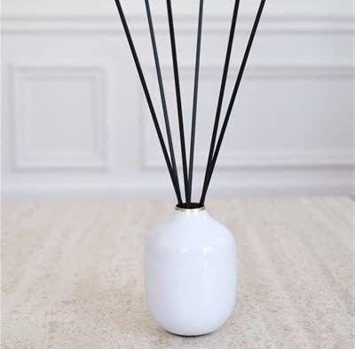 Petit Vase Blanc rond pour bouquet parfumé avec tiges noires élégantes insérées à l’intérieur.
