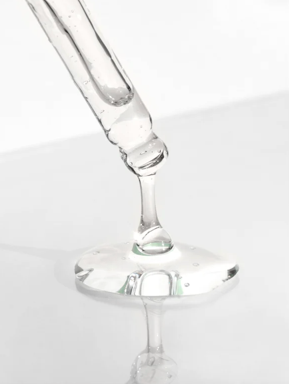 Goutte d'énergie : pipette déposant une substance claire sur une surface, symbolisant le Gel énergisant à la caféine.